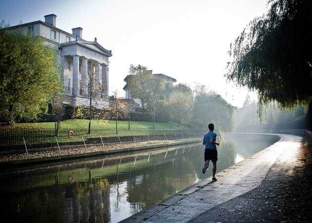 Photo of person running by a river